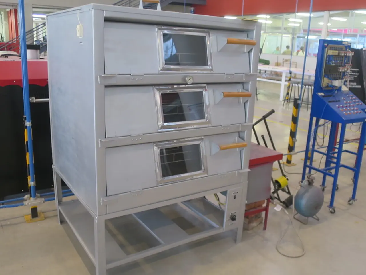 In the image there are many electrical equipment and metal racks in the front, it seems to be a...