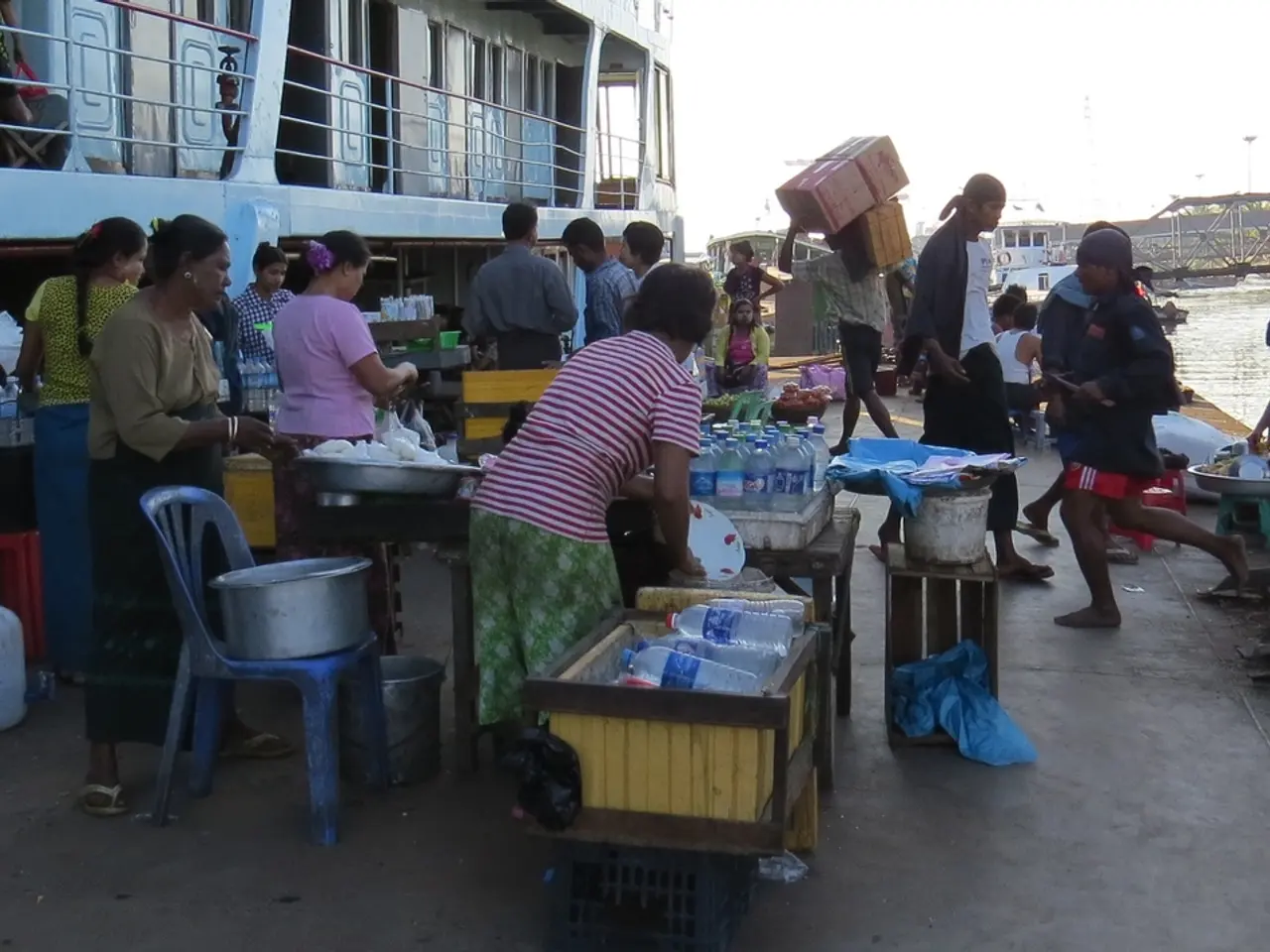 In this picture there are group of people who are busy with their work. There is a chair on which...