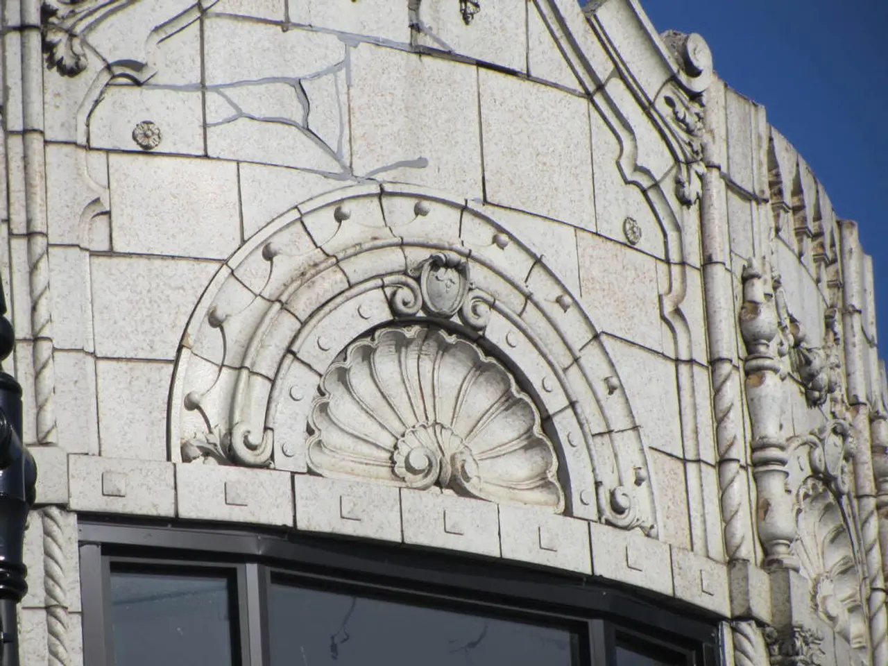 In the center of the image there is a building with sculptures on it. At the top of the image there...