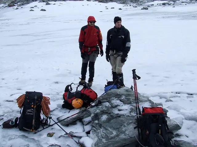 In this picture there is a man who is wearing a red jacket and goggles on his eyes. He is also...