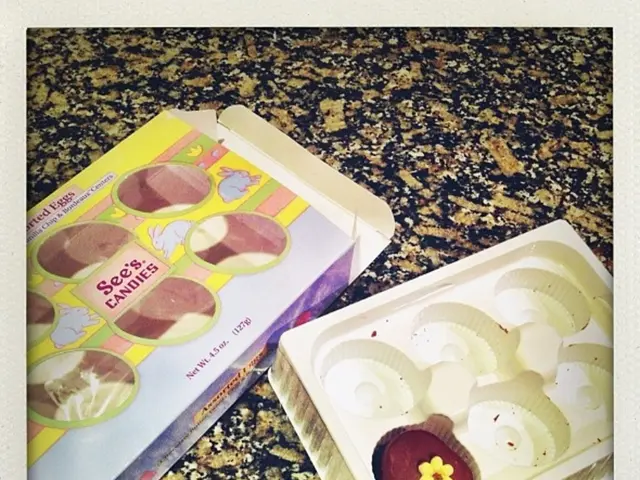 In this image there is a box. Beside there is a tray having some food in it. They are kept on the...