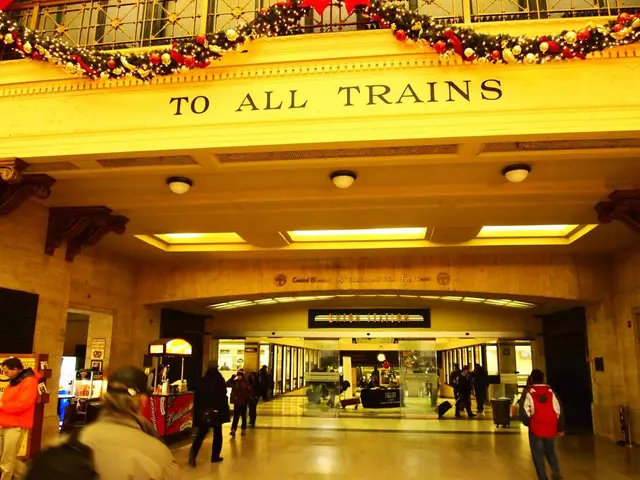 In the image it seems like a train station, there are few people on the floor and there is a...